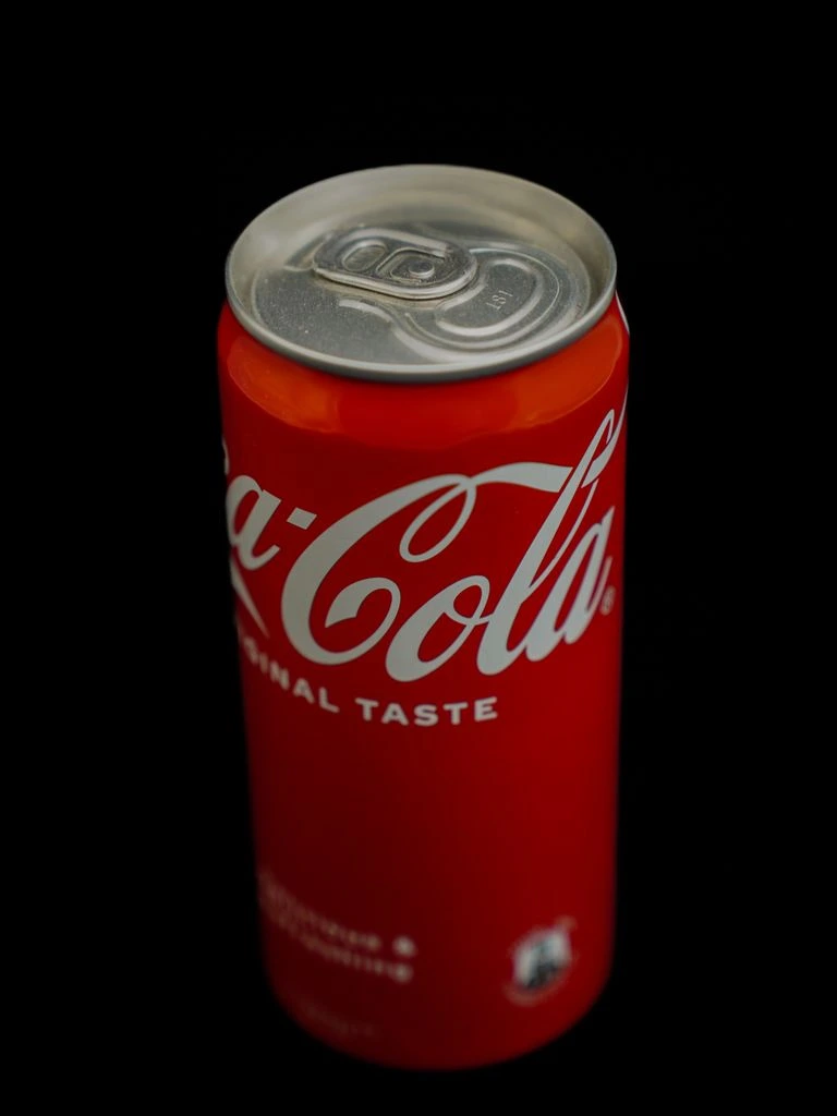 A 1940s embossed tin Coca-Cola advertising sign with original patina